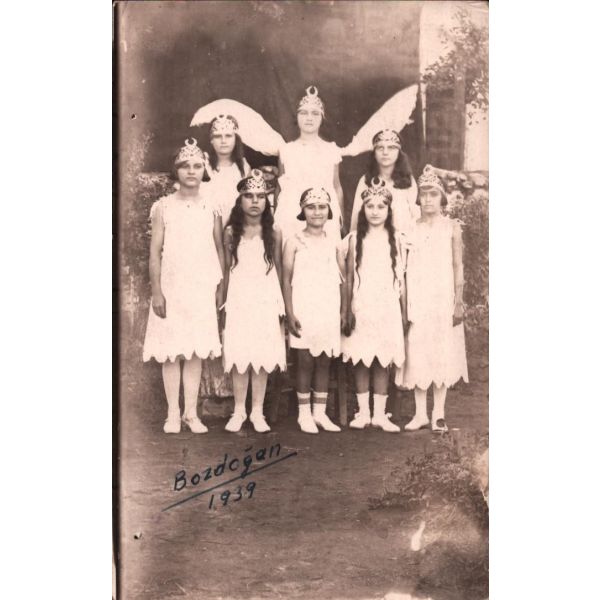 Bir millî bayram töreni için beyaz elbiselere bürünüp hilalli taçlar takmış Bozdoğanlı kızların alamünit bir hatırası, 1939 tarihli, 9x14 cm